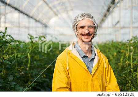 Happy young agronomist enjoying working in hothouse 69512329