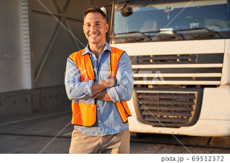 Driver standing near his truck 69512372