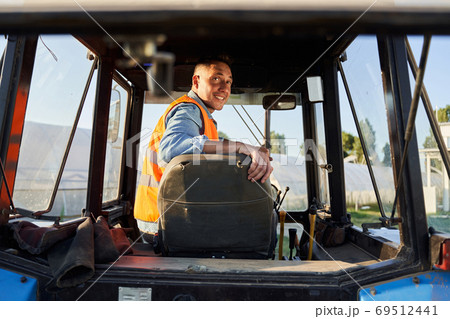 Tractor cap interior with worker 69512441