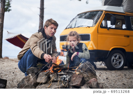 Daughter communicates with dad near the fire 69513268