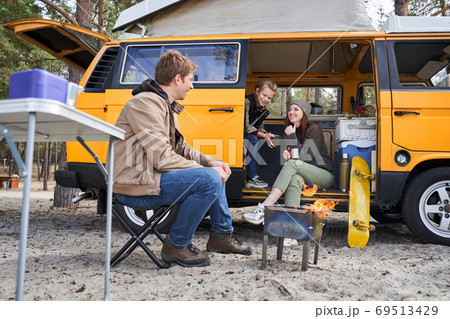 Family enjoying picnic near campfire Family enjoying picnic near campfire 69513429