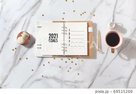 New Year Resolution Goal List 2020 - Business office desk with notebook about plan listing of new year goals and resolutions setting. Change and determination concept. 69515200