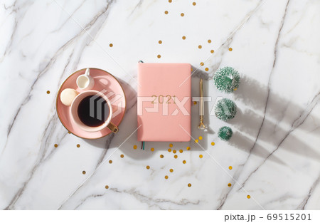 Flat lay composition with New Year's decoration, coral colored 2021 diary book and coffee cup 69515201