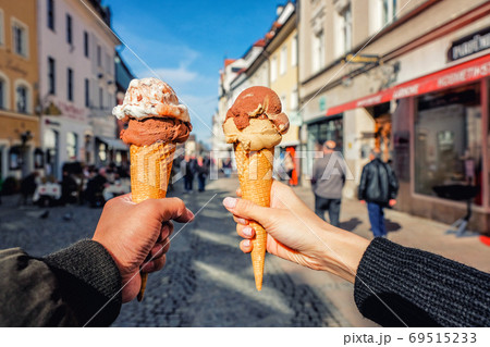Young couple having fun and enjoy to eating ice cream in Fussen, Young couple having fun and enjoy to eating ice cream in Fussen, 69515233
