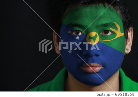 Portrait of a man with the flag of the Christmas Island painted Portrait of a man with the flag of the Christmas Island painted 69518559