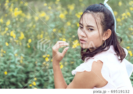 Portrait of asian happy woman smilling with flower garden , Sele Portrait of asian happy woman smilling with flower garden , Sele 69519132