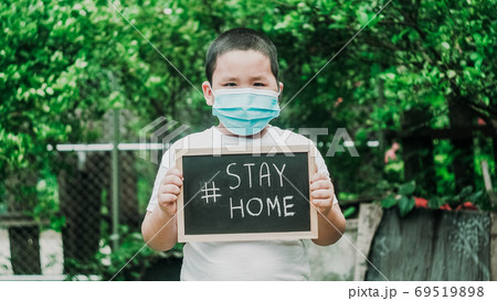 Stay at home.Little asian boy wearing face masks to prevent viru 69519898