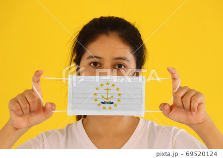 A woman and hygienic mask with Rhode Island flag pattern in her A woman and hygienic mask with Rhode Island flag pattern in her 69520124