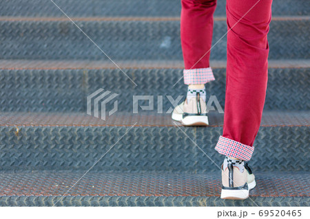 Close-up of man's shoes walking upstairs 69520465