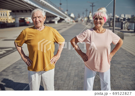 Modern senior fit married couple looking ahead Modern senior fit married couple looking ahead 69522827