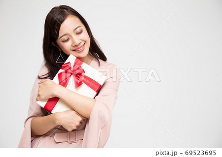 Happy beautiful asian woman smile and hugging gift box. 69523695