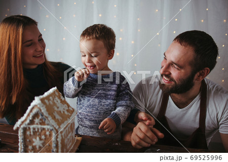 Mother, father and son hugging. Christmas time 69525996