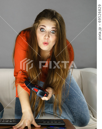 Young woman playing video games Young woman playing video games 69526829