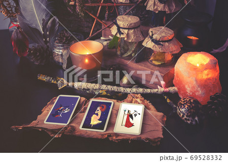 3 Tarot cards spread lying on a black table with magic items. Toned to cold colors 69528332