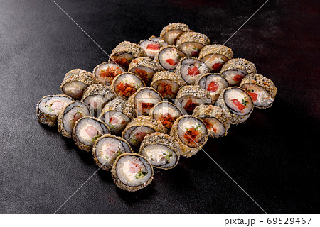 Fresh delicious beautiful sushi rolls on a dark background 69529467