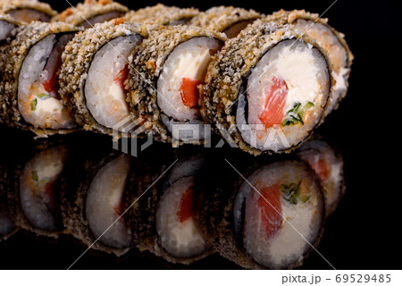 Fresh delicious beautiful sushi rolls on a dark background 69529485
