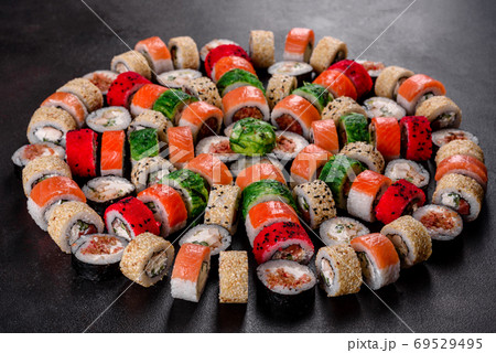 Fresh delicious beautiful sushi rolls on a dark background Fresh delicious beautiful sushi rolls on a dark background 69529495