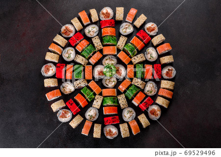 Fresh delicious beautiful sushi rolls on a dark background Fresh delicious beautiful sushi rolls on a dark background 69529496