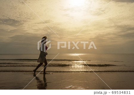 cheerful woman in bikini walking on sea beach 69534831