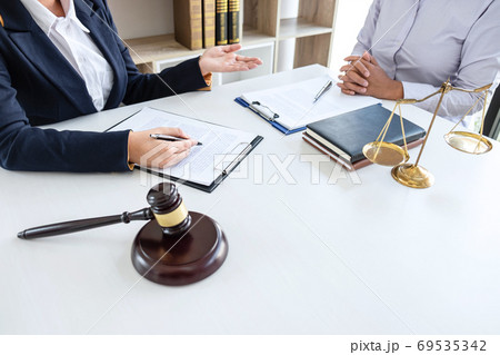 Professional female lawyer or counselor discussing Professional female lawyer or counselor discussing 69535342