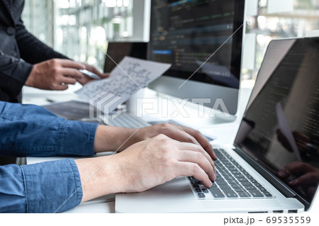 Team of developer programmer working on project in 69535559
