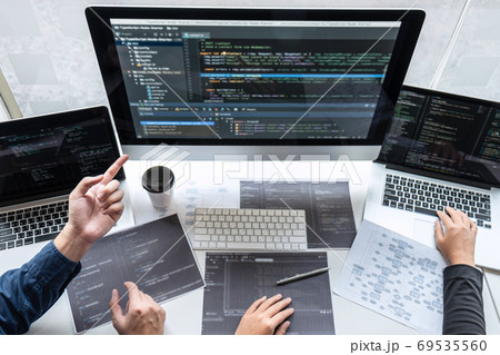 Team of developer programmer working on project in Team of developer programmer working on project in 69535560