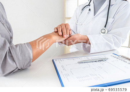 Hand of doctor touching patient reassuring for Hand of doctor touching patient reassuring for 69535579