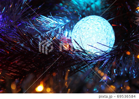 Christmas ball with light. Christmas evening background. 69536584