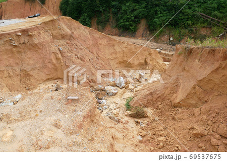 Erosion at ground and slopes is caused by rainfall. The soil structure is weak and there is a landslide. Safety measure has been taken in some area. 69537675
