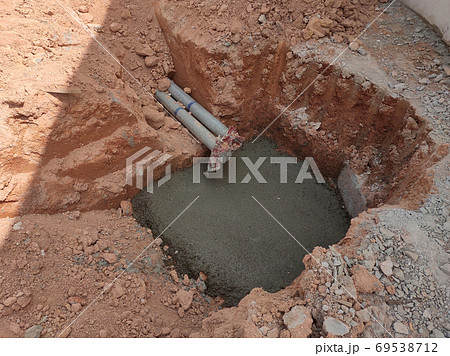 SEREMBAN, MALAYSIA -AUGUST 5, 2020: Utility services manhole and underground pipes under construction at the construction site. In-situ construction by workers based on infrastructure engineer design. SEREMBAN, MALAYSIA -AUGUST 5, 2020: Utility services manhole and underground pipes under construction at the construction site. In-situ construction by workers based on infrastructure engineer design. 69538712