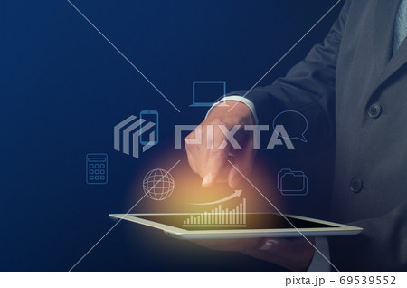 businessman use tablet computer with bar graph and digital symbol. business efficiency and effectiveness presentation concept businessman use tablet computer with bar graph and digital symbol. business efficiency and effectiveness presentation concept 69539552
