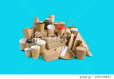 Many Various take-out food containers, pizza box, coffee cups in holder and paper boxes on aqua blue background. 69539841