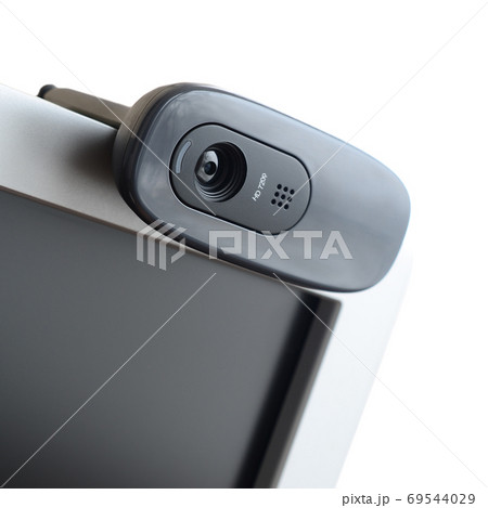 A modern web camera is installed on the body of a flat screen mo A modern web camera is installed on the body of a flat screen mo 69544029