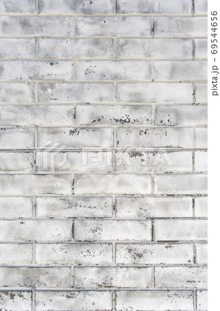 Old wall made of white brick. Rough textured surface. Construction background. Vertical frame. 69544656