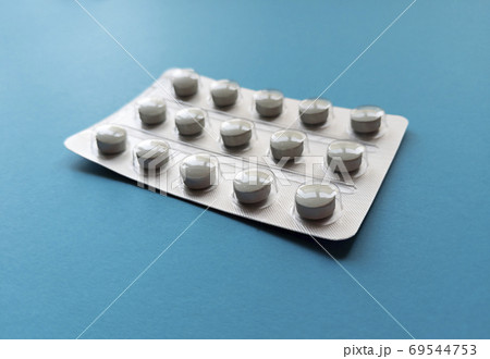 A blister of tablets on blue background. Medical concept. Stock photo. 69544753