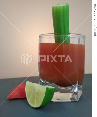 True Bloody Mary Cocktail celery stick lemon and tomato slice. 69545248