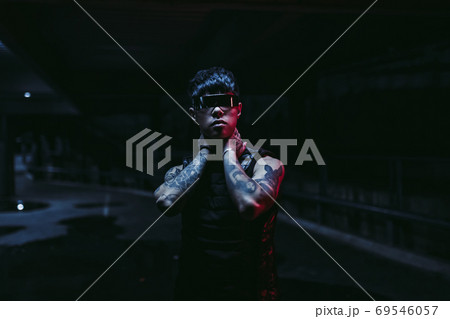Night portrait of a man in futuristic glasses. A new trend of cyberpunk. 69546057