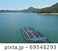Floating solar panel on the lake with mountain background. This technology called FPV or Floating photovoltaic. Produce electricity in a clean technology concept and output is renewable energy. 69548293