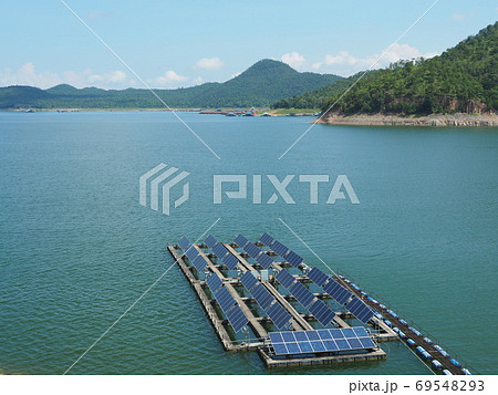 Floating solar panel on the lake with mountain background. This technology called FPV or Floating photovoltaic. Produce electricity in a clean technology concept and output is renewable energy. 69548293