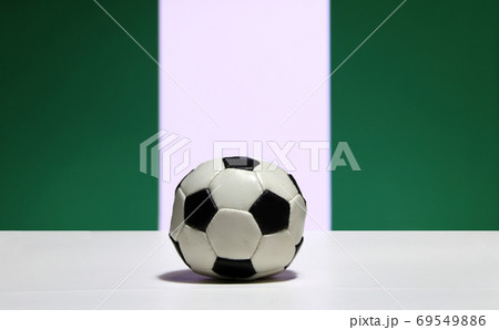 Small football on the white floor and white color between green 69549886