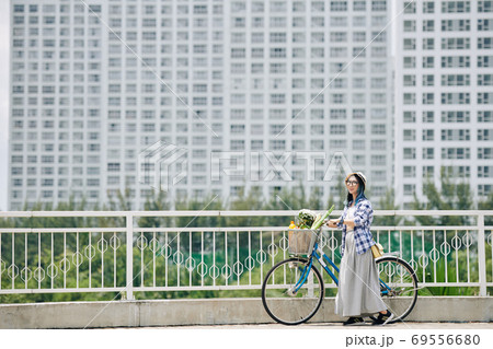 Happy woman with bicycle Happy woman with bicycle 69556680