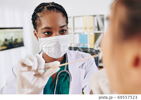 Doctor asking patient to open mouth Doctor asking patient to open mouth 69557523