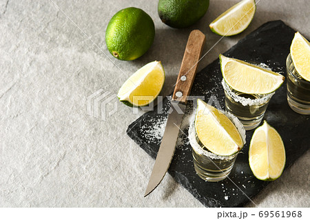 Mexican Gold tequila with lime and salt on black background. Top view. Copyspace	 69561968
