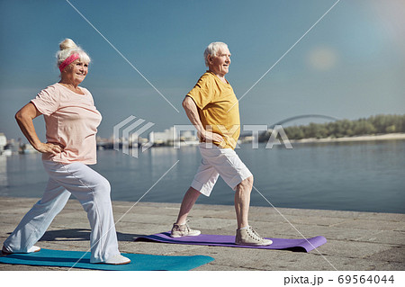 Two Caucasian pensioners enjoying their yoga workout 69564044