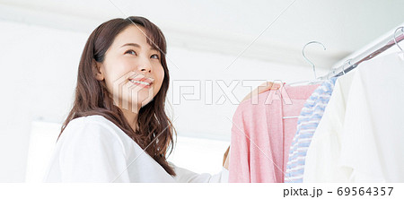 服を選ぶ笑顔の若い女性　バナーサイズ 69564357