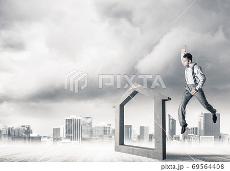 Manager man crashing stone home as symbol for real estate insurance 69564408