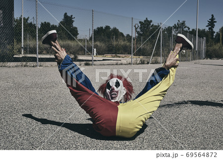 clown lying on the floor with his legs raised 69564872