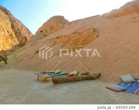 Bedouin village in Sahara desert on mountain landscape Bedouin village in Sahara desert on mountain landscape 69565399