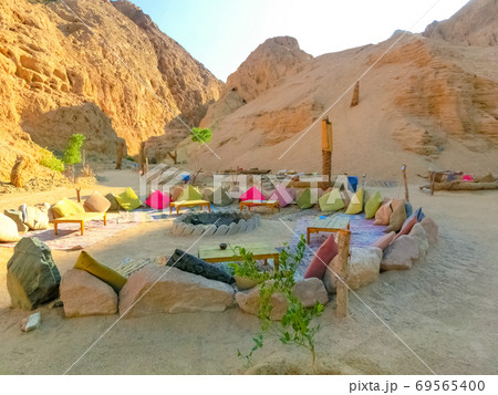 Bedouin village in Sahara desert on mountain landscape 69565400