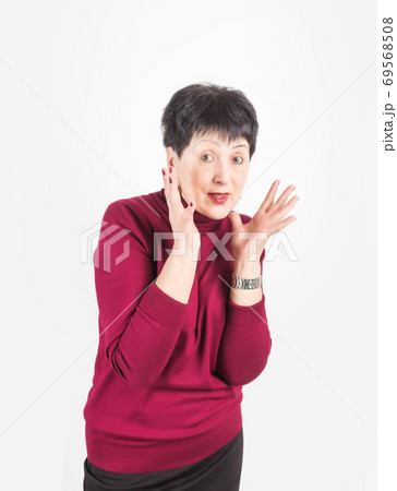 Portrait of stylish, aged, charming, surprised, shocked woman over grey background Portrait of stylish, aged, charming, surprised, shocked woman over grey background 69568508